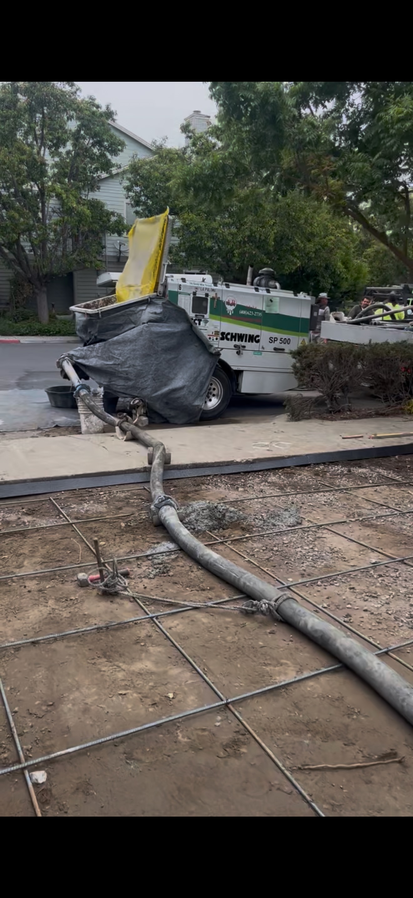 Concrete hose extending down sidewalk